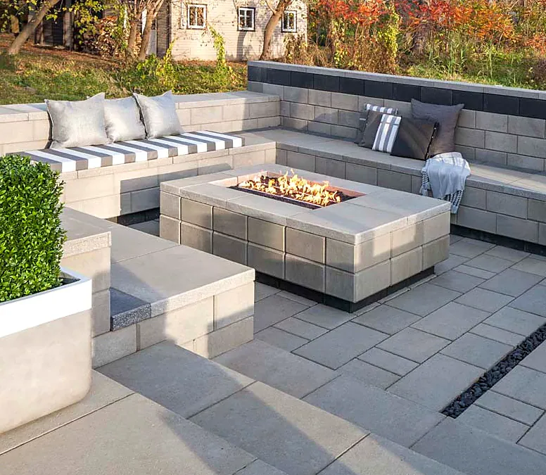Interlock patio with built-in seat walls around a gas fire table