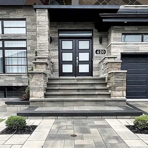 Stone front steps leading to a modern front door
