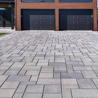 Driveway in large-format pavers in front of a two-car garage